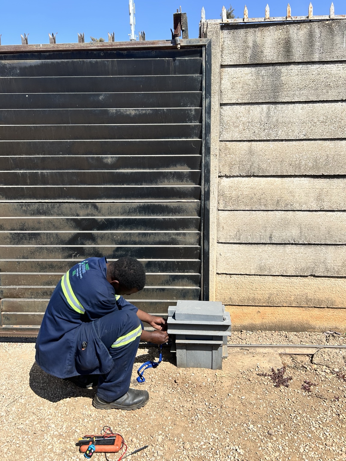 DCAST technician servicing a sliding gate motor